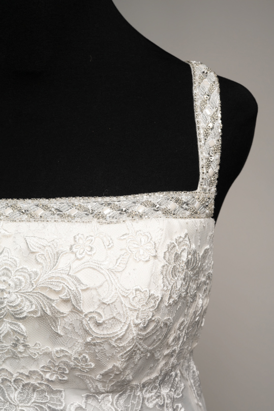 Détail du bustier en dentelle perlée et de l'organza de la robe de location Lya